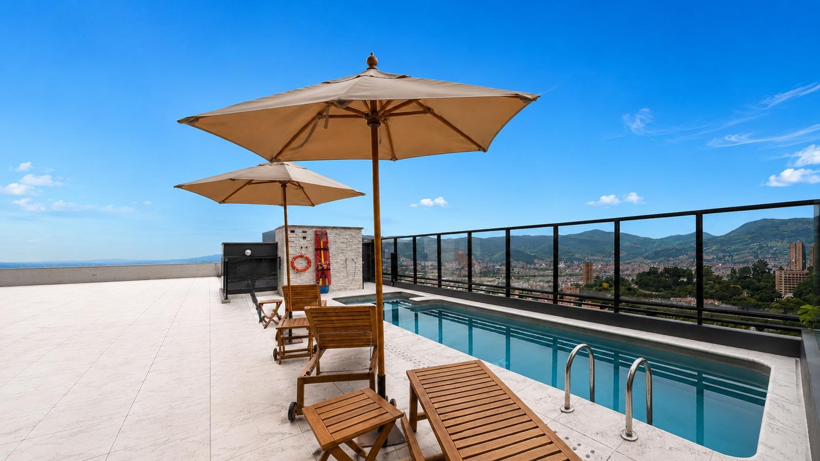 Rooftop pool with Medellín skyline and mountains